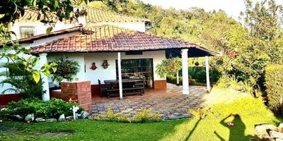 En el tranquilo municipio de Guarne, Antioquia, se encuentra esta hermosa casa en venta con una ubicación privilegiada y un área total de 1240 metros cuadrados.

La propiedad cuenta con una construcción de 300 metros cuadrados, distribuidos en una amplia sala, comedor y cocina integral con acabados en cerámica y mármol, que le dan un toque elegante y moderno a los espacios. Además, cuenta con una biblioteca o estudio, ideal para trabajar desde casa, y un baño auxiliar para mayor comodidad.

Dispone de 8 habitaciones, cada una con su propio baño, lo que la convierte en la opción ideal para una familia numerosa o para aquellos que buscan un lugar con suficiente espacio para recibir invitados. La habitación principal cuenta con baño privado y un espacio acogedor que puede ser utilizado como sala de estar o para relajarse junto a la chimenea.

La casa dispone de un área de lavandería, depósito y suficientes espacios de garaje, con capacidad para 8 vehículos, para que tus visitantes siempre tengan un lugar seguro para aparcar.

Pero lo mejor de esta propiedad es su hermosa zona externa, perfecta para disfrutar de la naturaleza y el aire libre. Cuenta con acceso pavimentado desde la carretera principal y un amplio jardín con zonas verdes y árboles frutales que rodean la vivienda. Además, ofrece una zona de barbacoa y una espectacular vista al bosque nativo que le da un toque de tranquilidad y paz.

La ubicación también es un gran beneficio, ya que se encuentra en una zona residencial, alejada del ruido de la ciudad pero cercana a las zonas urbanas, con fácil acceso a tiendas, centros comerciales y transporte público. El conjunto residencial cuenta con vigilancia las 24 horas y circuito cerrado de televisión para garantizar la seguridad de sus habitantes.

Esta propiedad es perfecta para aquellos que buscan un lugar para desconectarse de la ciudad y disfrutar de un entorno campestre, pero con todas las comodidades y lujos de una casa moderna. ¡No pi